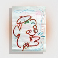 a drawing of a face on a piece of paper